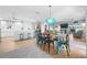 Open concept living and dining area featuring stylish decor, wood flooring, and modern lighting fixtures at 10532 94Th Pl, Seminole, FL 33772