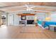 Bright main bedroom with wood beam ceilings, white brick fireplace, and adjacent exterior access at 10532 94Th Pl, Seminole, FL 33772