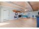 Bright main bedroom with wood beam ceilings, white brick fireplace, and access to laundry room at 10532 94Th Pl, Seminole, FL 33772