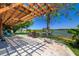 Cozy outdoor patio with a pergola overlooking the water and private dock, perfect for entertaining at 10532 94Th Pl, Seminole, FL 33772