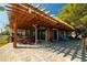 A home patio with outdoor seating, dining, and a wooden pergola providing ample shade at 10532 94Th Pl, Seminole, FL 33772