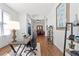 Well-lit office space showcasing hardwood floors, a modern desk, and stylish shelving with decorative accents at 1327 Yardley Dr, Wesley Chapel, FL 33544