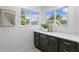 Bright bathroom features dual windows, dark wood cabinets, and white countertops at 156 29Th N Ave, St Petersburg, FL 33704