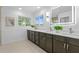 Elegant bathroom with dual sinks, dark wood cabinets and lots of natural light at 156 29Th N Ave, St Petersburg, FL 33704