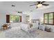 Bright bedroom features wood shutters, neutral decor, ceiling fan, and a comfortable sitting area at 156 29Th N Ave, St Petersburg, FL 33704
