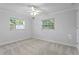 Cozy bedroom with natural light from two windows and neutral carpeting at 156 29Th N Ave, St Petersburg, FL 33704