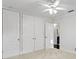 Bright bedroom featuring white walls, carpet, a ceiling fan, and closet storage at 156 29Th N Ave, St Petersburg, FL 33704