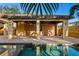 Inviting cabana featuring wood cabinetry, bar, and sparkling pool surrounded by a brick patio at 156 29Th N Ave, St Petersburg, FL 33704
