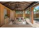 Relaxing cabana with comfortable seating, a wet bar, and a lovely view of the sparkling pool and backyard at 156 29Th N Ave, St Petersburg, FL 33704