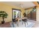 Cozy covered patio with a ceiling fan, dining table, and seamless indoor-outdoor flow through elegant doors at 156 29Th N Ave, St Petersburg, FL 33704