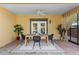 Charming covered patio with a dining table, ceiling fan, and a smooth transition to the outdoors through stylish doors at 156 29Th N Ave, St Petersburg, FL 33704