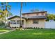 Charming two-story home features a beautiful tile roof and well-manicured lawn, complemented by lush tropical landscaping at 156 29Th N Ave, St Petersburg, FL 33704
