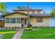 Home exterior with a lush lawn, plants, a paver walkway, and well-manicured landscaping at 156 29Th N Ave, St Petersburg, FL 33704