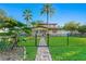 Charming home with lush lawn, tropical foliage, and secure black metal fencing, perfect curb appeal at 156 29Th N Ave, St Petersburg, FL 33704