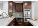 Well-appointed kitchen with dark wood cabinets, stainless steel appliances, and granite countertops at 156 29Th N Ave, St Petersburg, FL 33704