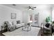 Bright living room with neutral decor, hardwood floors, and French doors overlooking the pool at 156 29Th N Ave, St Petersburg, FL 33704