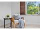 Cozy chair with throw and pillow beside a window with wood shutters at 156 29Th N Ave, St Petersburg, FL 33704