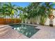 Sparkling swimming pool surrounded by lush landscaping, beautiful brick patio, and a privacy fence at 156 29Th N Ave, St Petersburg, FL 33704