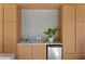 Wet bar with modern cabinetry, mosaic backsplash, sink and mini refrigerator offering a touch of luxury at 156 29Th N Ave, St Petersburg, FL 33704