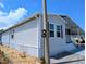 Exterior view of a well-maintained home featuring light siding and dark shutters at 206 S Port Royal Ln, Apollo Beach, FL 33572