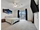 Spacious main bedroom with balcony access, a ceiling fan, and a television at 206 S Port Royal Ln, Apollo Beach, FL 33572