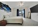 Spacious main bedroom with balcony access, a ceiling fan, and a television at 206 S Port Royal Ln, Apollo Beach, FL 33572