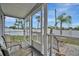 Enjoy views on this screened porch with seating and access to the yard at 206 S Port Royal Ln, Apollo Beach, FL 33572