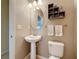 Cozy bathroom with pedestal sink, decorative oval mirror, and fresh towels at 6467 Willowshire Way, Bradenton, FL 34212