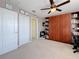 Multi-purpose room with carpeted floors, a ceiling fan, and a built-in bookshelf and Murphy bed at 6467 Willowshire Way, Bradenton, FL 34212