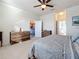 Bright bedroom with carpeted floors and ceiling fan offering views of the nearby kitchen and bathroom at 6467 Willowshire Way, Bradenton, FL 34212
