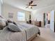 Comfortable bedroom featuring carpeted floors, a ceiling fan, and a view of the outdoor patio area at 6467 Willowshire Way, Bradenton, FL 34212