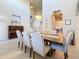 Elegant dining room showcasing high ceilings, classic piano, and beautiful chandelier lighting at 6467 Willowshire Way, Bradenton, FL 34212