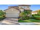 Attractive two-story home with a tile roof, attached garage, and manicured landscaping at 6467 Willowshire Way, Bradenton, FL 34212
