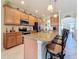 Modern kitchen with granite countertops, stainless appliances, and breakfast bar with seating at 6467 Willowshire Way, Bradenton, FL 34212