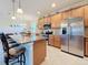 Well-equipped kitchen with stainless steel appliances, granite countertops, and a breakfast bar at 6467 Willowshire Way, Bradenton, FL 34212
