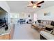 Spacious living room with plush seating, carpeted floors, and a loft area with a piano at 6467 Willowshire Way, Bradenton, FL 34212