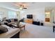 Cozy living room features plush seating, carpeted floors, a ceiling fan, and a view of the nearby bathroom at 6467 Willowshire Way, Bradenton, FL 34212