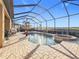 A screened-in patio features a lovely private pool and spa, perfect for relaxation and entertaining at 6467 Willowshire Way, Bradenton, FL 34212