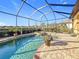 Screened-in pool and spa with brick surround offer a relaxing outdoor oasis in this inviting backyard at 6467 Willowshire Way, Bradenton, FL 34212