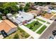Aerial shot of a home with pristine landscaping, a fenced backyard, sheds and a unique roof at 8807 Oak Cir, Tampa, FL 33615