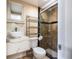 Modern bathroom featuring a glass-enclosed shower, stylish sink, and contemporary fixtures at 8807 Oak Cir, Tampa, FL 33615
