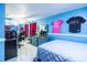 Vibrant bedroom with light blue walls, tiled floors, mirrored closet doors, and gaming setup at 8807 Oak Cir, Tampa, FL 33615