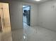 Bright bedroom showcasing modern flooring and a walk-in closet with kitchen access at 8807 Oak Cir, Tampa, FL 33615
