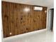 Bedroom with wood-paneled walls, modern flooring, and split-unit air conditioning at 8807 Oak Cir, Tampa, FL 33615