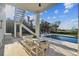 Relaxing pool area with a covered patio and a table, perfect for outdoor enjoyment at 1640 Sea Breeze Dr, Tarpon Springs, FL 34689