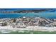 Aerial view of a beachfront community with turquoise water, sandy beaches, and coastal homes at 308 2Nd St N # 202, Bradenton Beach, FL 34217