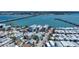 Beautiful neighborhood with colorful homes, lush palm trees, and a bridge, offering a picturesque coastal lifestyle at 308 2Nd St N # 202, Bradenton Beach, FL 34217