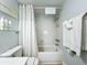 Bathroom featuring shower with curtain, white tile, shower caddy, and light blue walls at 308 2Nd St N # 202, Bradenton Beach, FL 34217