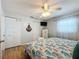 Bright bedroom featuring light wood floors, a ceiling fan and two closets for ample storage at 308 2Nd St N # 202, Bradenton Beach, FL 34217