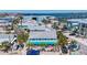 Charming beach house with a light blue exterior, white picket fence, and tropical landscaping at 308 2Nd St N # 202, Bradenton Beach, FL 34217